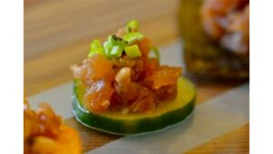 Spicy Tuna Tartare served with fresh avocado, crispy toppings, herbs, and bold spicy sauce for a gourmet seafood appetizer experience.