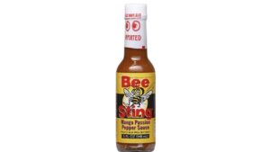 Bee Sting Mango Passion Pepper Sauce bottle with tropical mango and passion fruit flavor combined with sweet heat and spicy pepper blend for seafood chicken and tacos