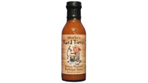 Bottle of Charlie’s Hard Times Honey Mustard Barbeque Sauce with sweet smoky mustard barbecue flavor